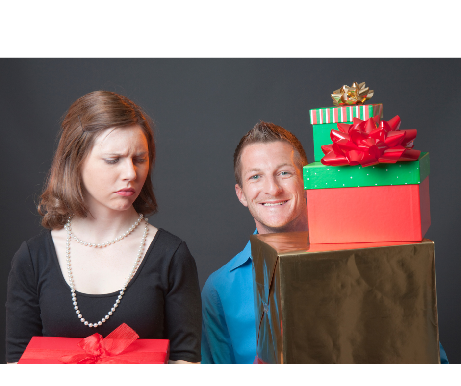 Image of a guy smiling with lots of gifts with a lady looking at him enviously with 1 gift in her hand. Workplace Envy