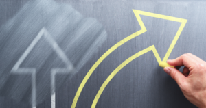 Image of a partially erased arrow pointing up and a bolder yellow arrow turning to the right